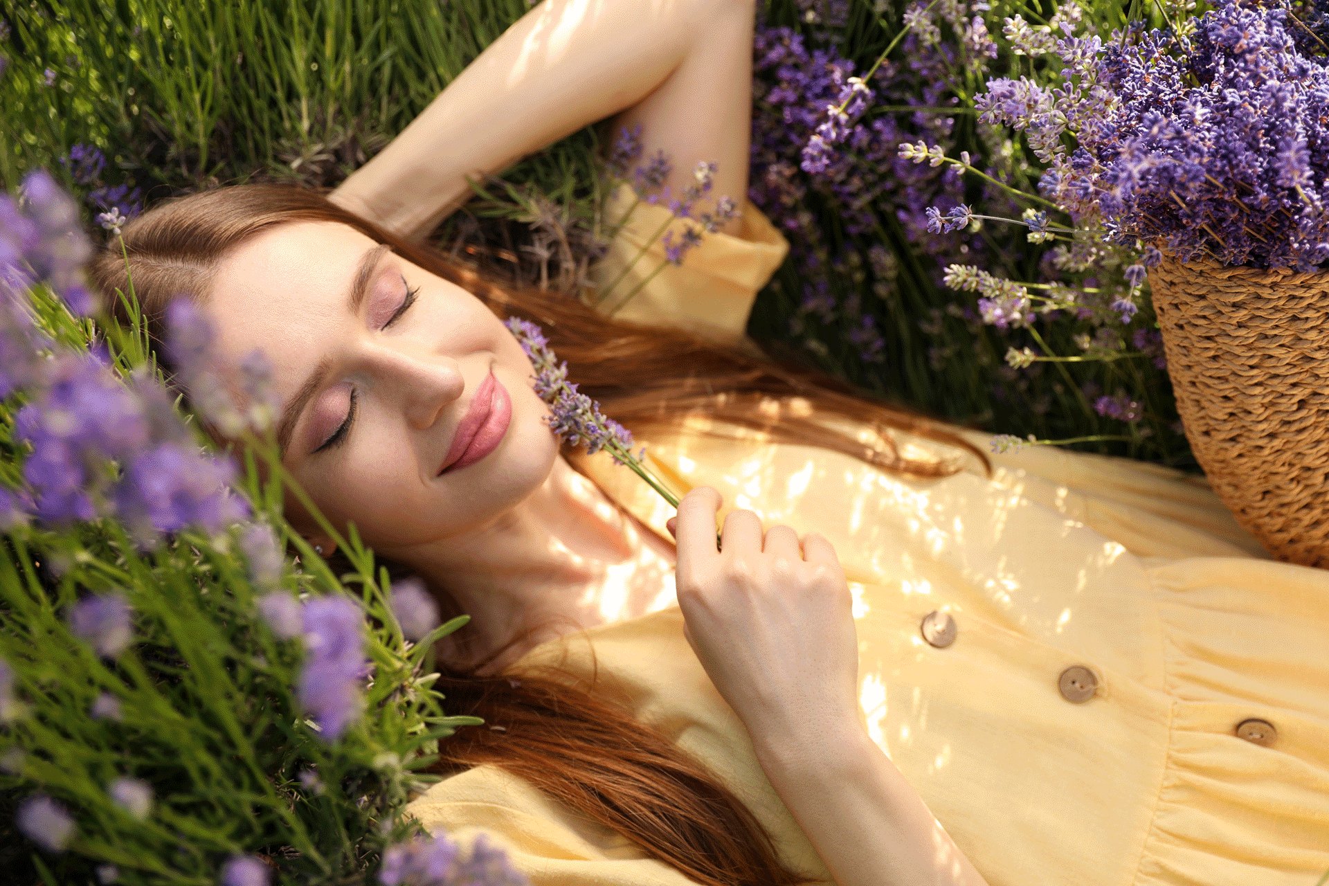 woman-relaxing-outside-smelling-flowers